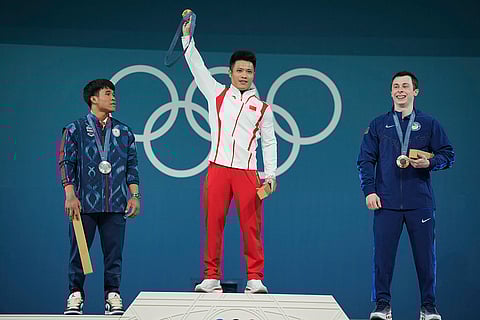 Paris Olympics men's 61kg weightlifting: Theerapong Silachai of Thailand, silver, Li Fabin of China, gold, and Hampton Morris of the United States, bronze